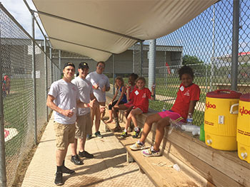 Panera Bread volunteers catching up with reds rookies in the dugout!